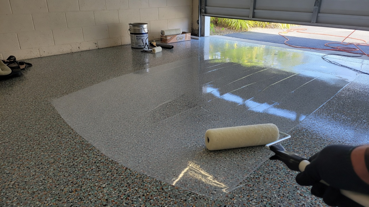 Polyaspartic topcoat rolled on flake epoxy garage floor